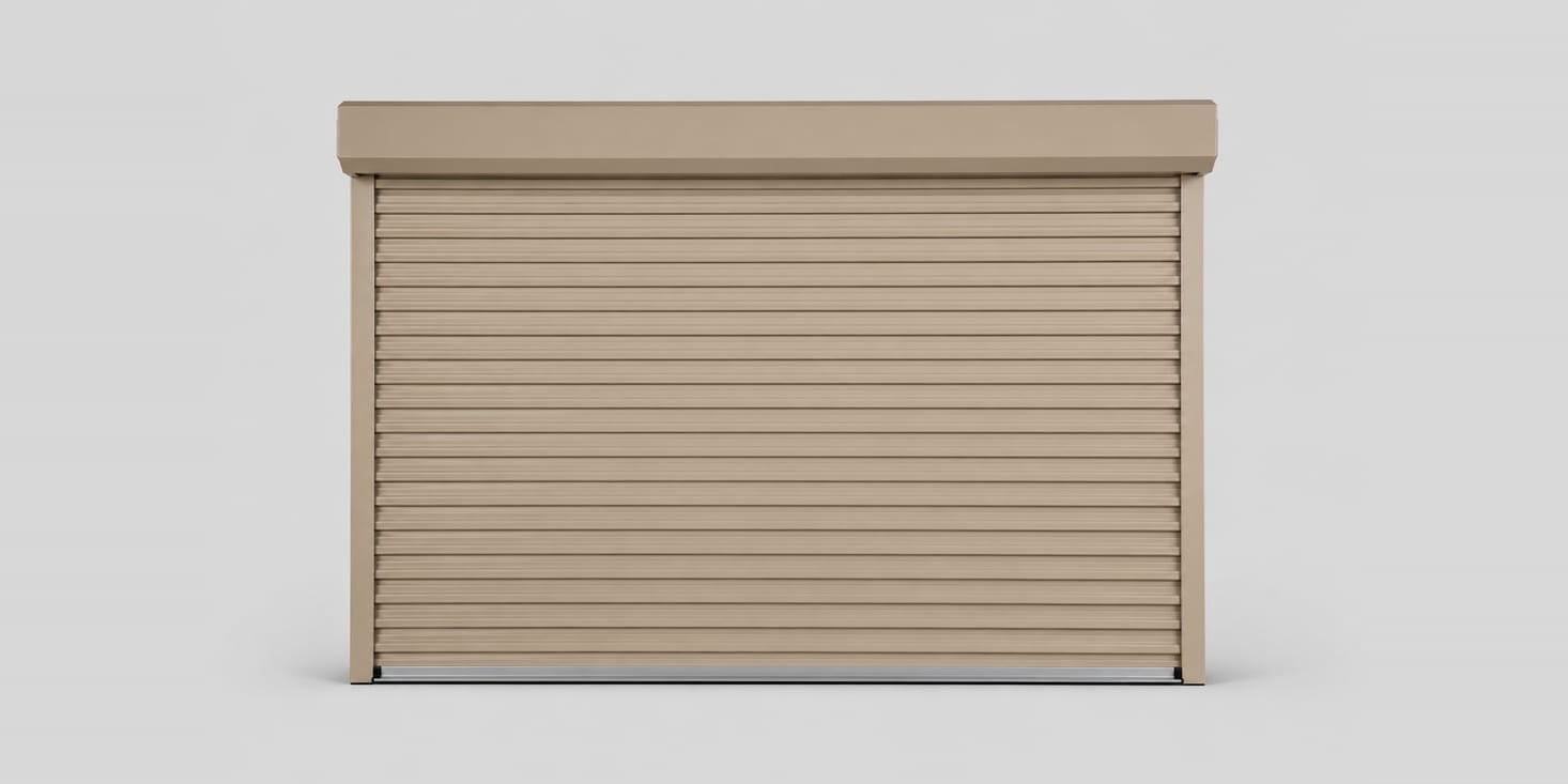 A tan steel roll-up door with its hood and side guides.